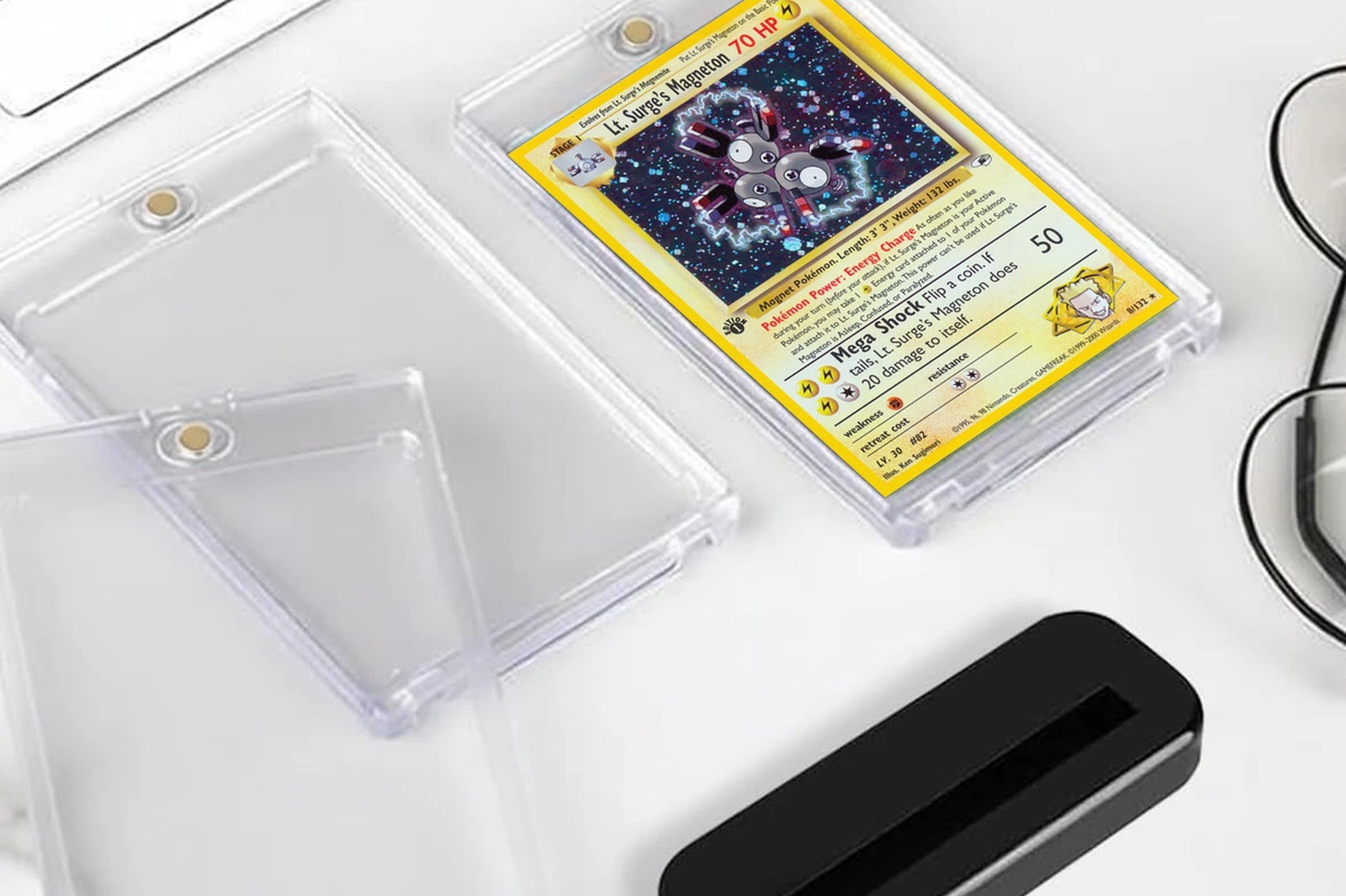 Magnetic card cases and a black stand, one holding a Pok&eacute;mon card